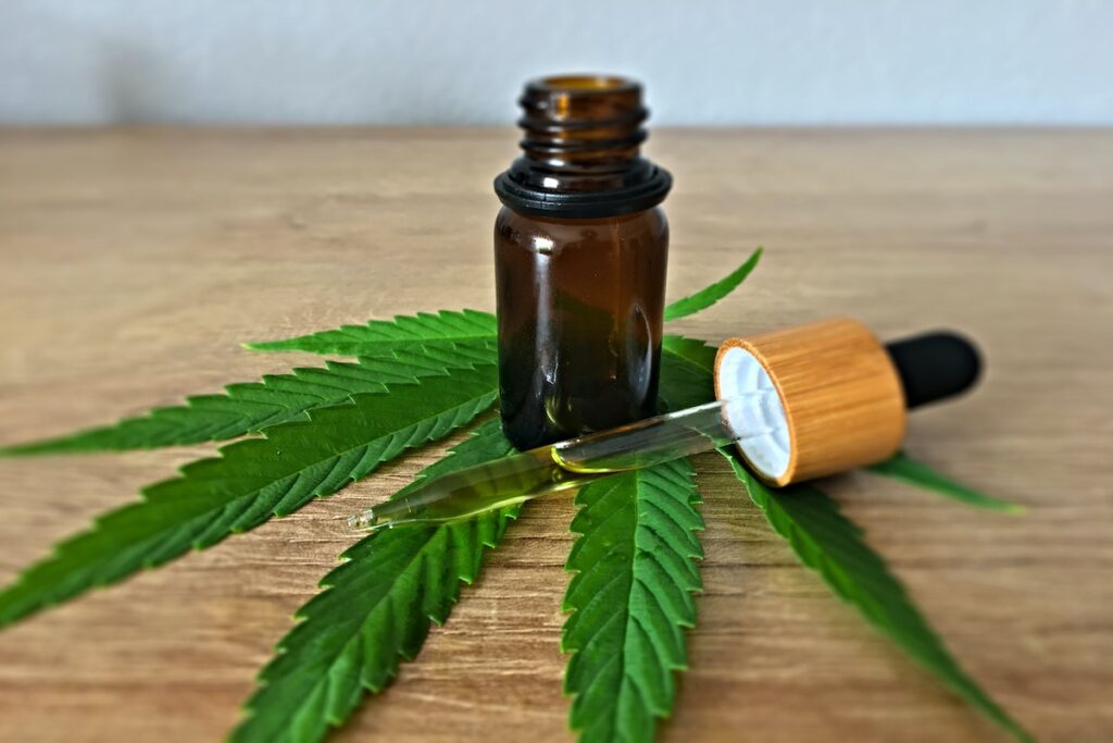 CBD in tincture form with a cannabis leaf. 