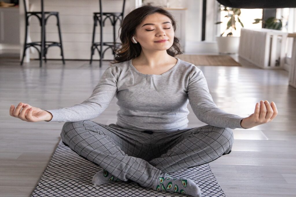 Woman practicing meditation for stress relief. 