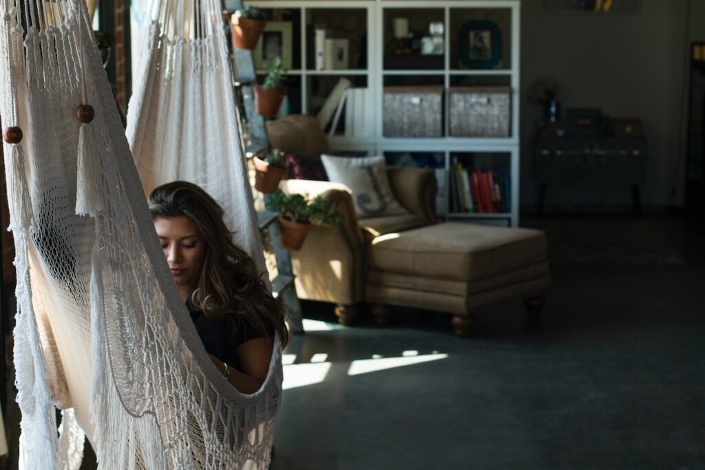 Woman in a hammock after taking one of the best cannabis strains to help her chill out. 