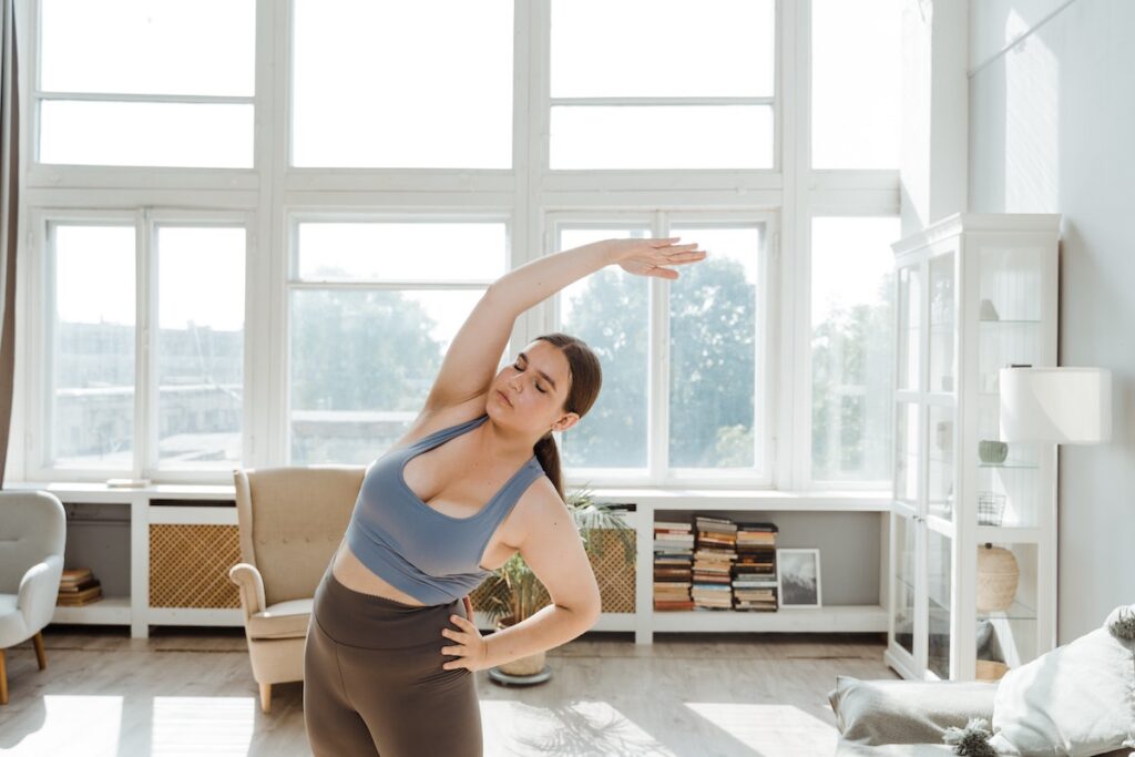 Woman doing yoga in her apartment. 