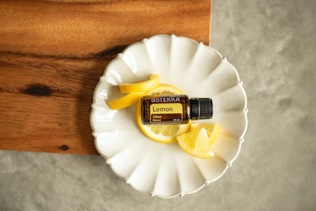 DoTerra essential oils in a bowl with lemon wedges. 