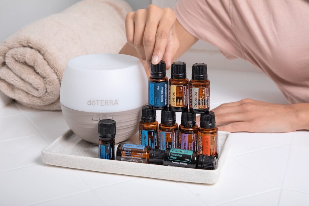 A full collection of essential oils for self-care and a diffuser. 
