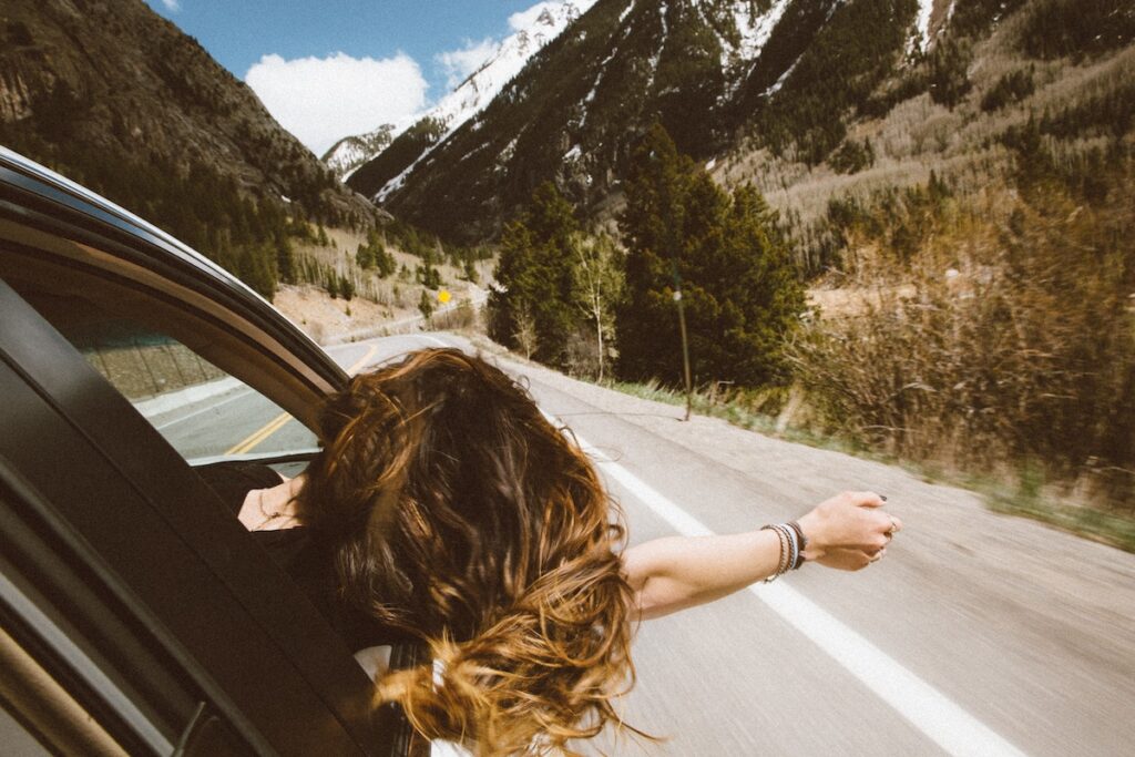 Woman on a road trip in the mountains. 