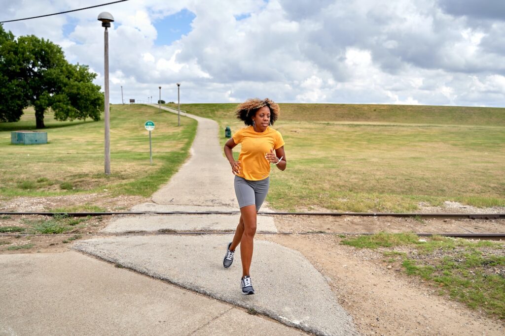 Woman running through a park. 