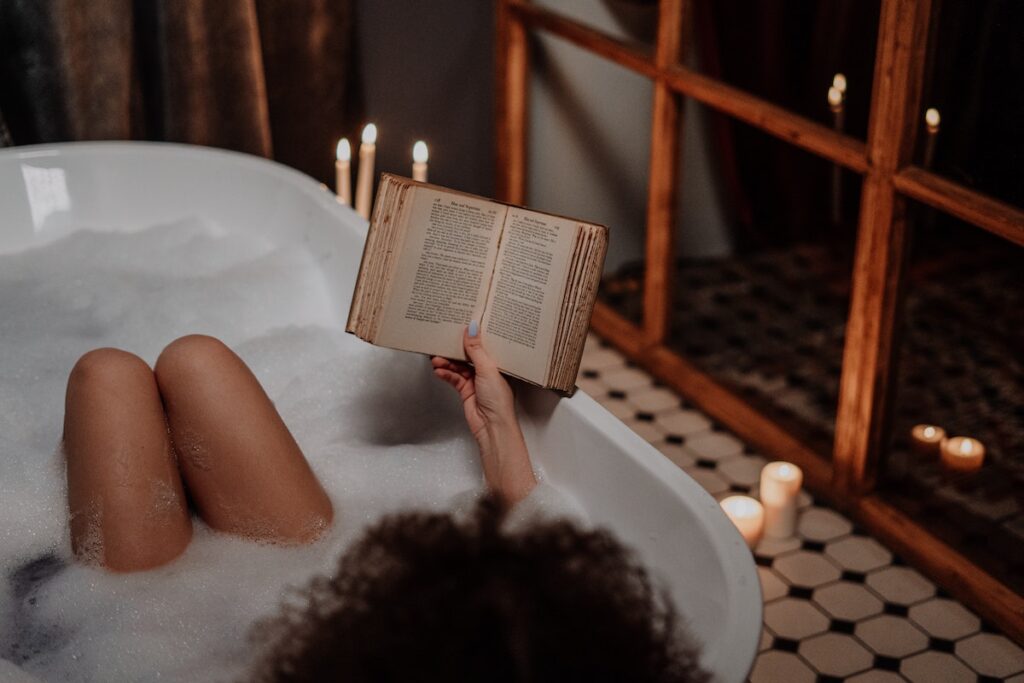 Woman in the bath reading a booj during the August full moon. 