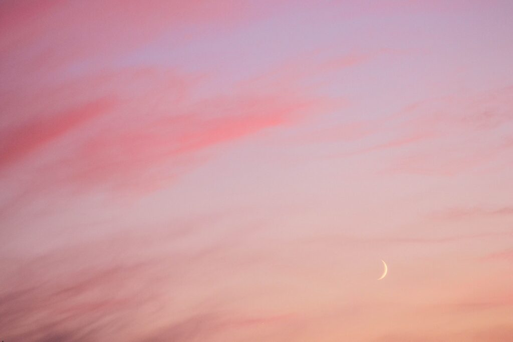 July new moon in the sky during sunset. 
