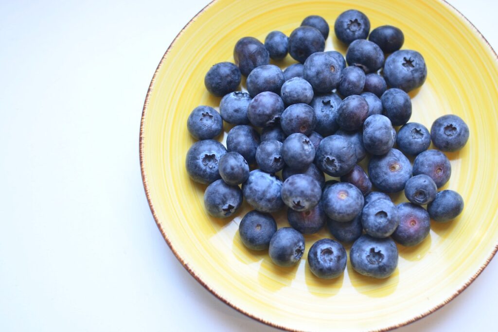 Blueberries on a plate during National Blueberry Month.