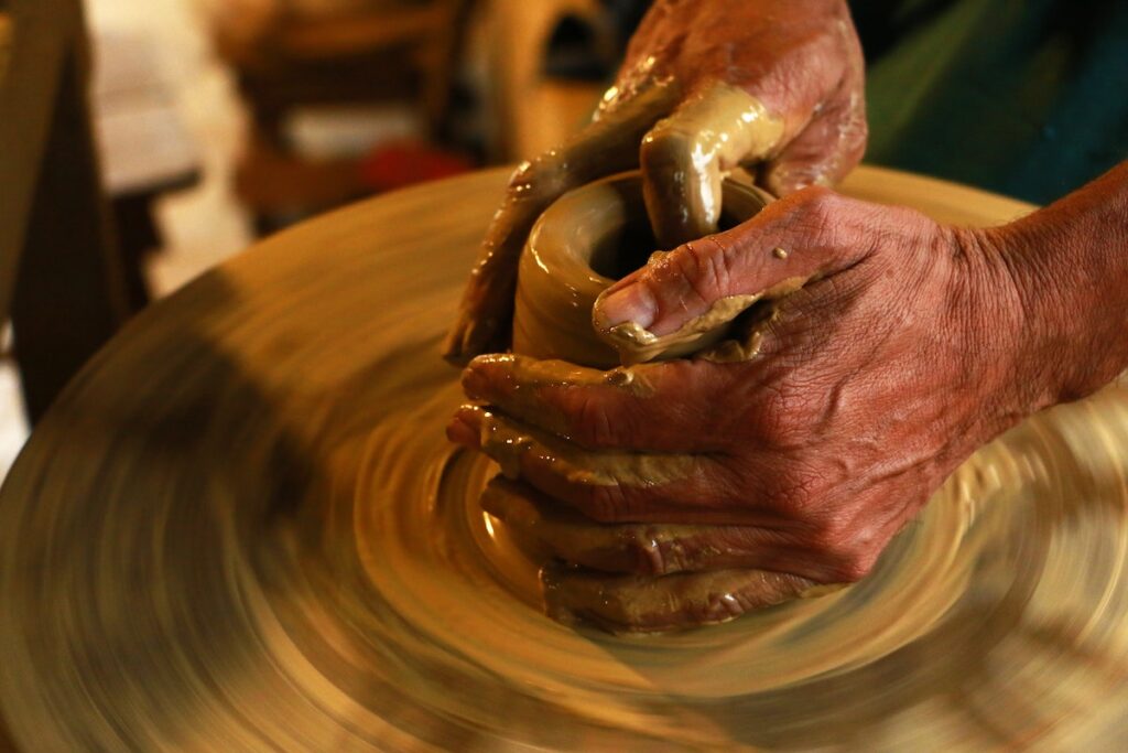 Clay on a spinning wheel to make pottery is one of the most meditative and unique self-care ideas.