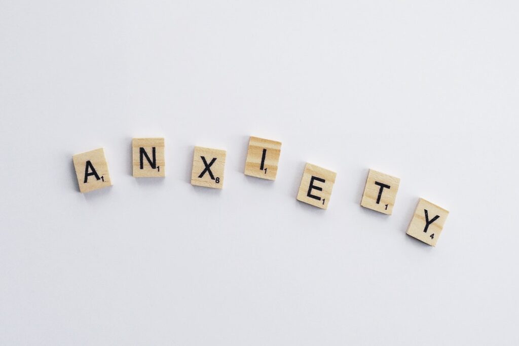 Scrabble letters spelling out "anxiety." 
