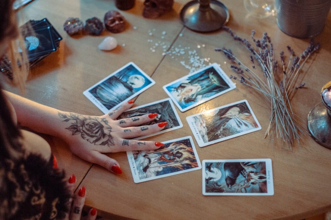 A woman using tarot cards during her new moon meditation. 