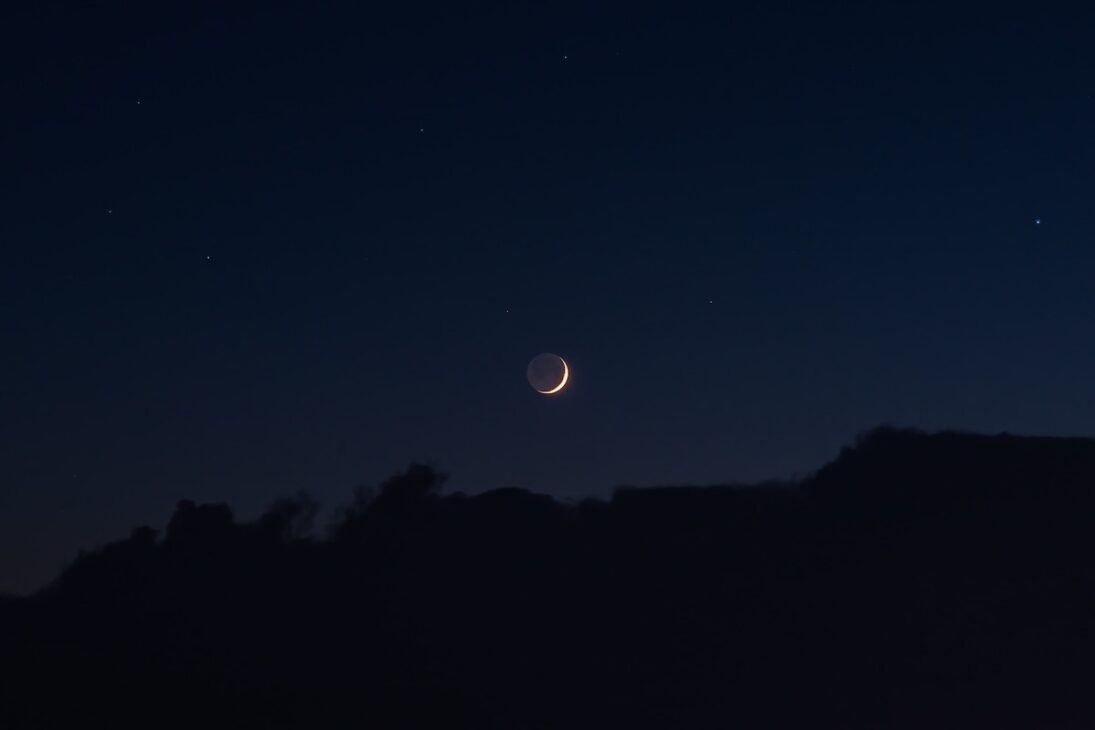 New moon in the night sky. 