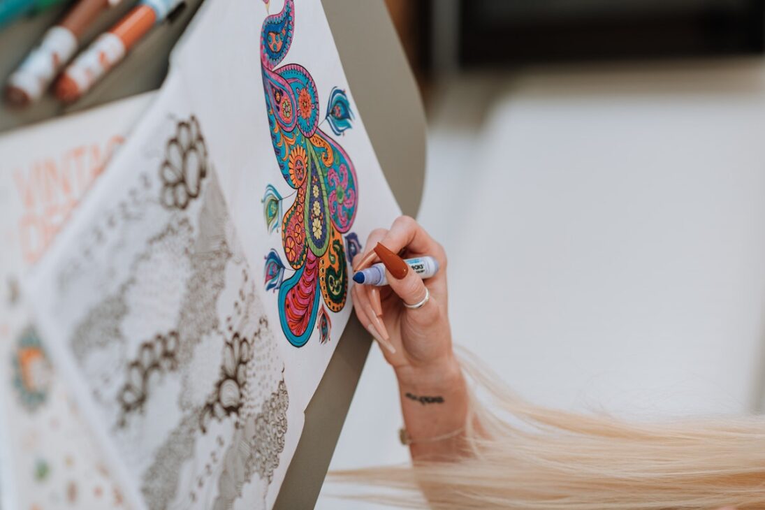 Woman coloring in a coloring book. 