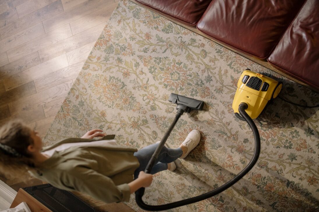 A woman cleaning the floor of her house. 