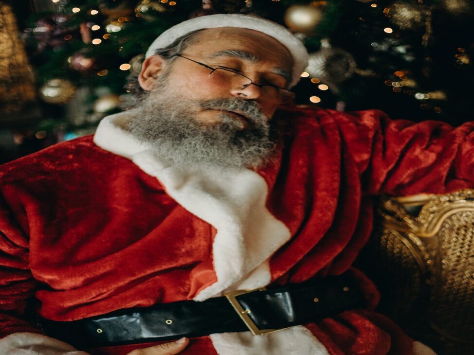 A sleeping Santa recommends sleep products on our holiday gift guide.