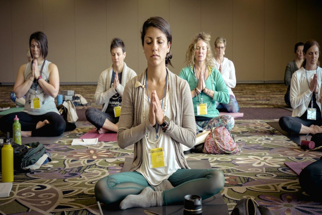 A group of women learning better meditation techniques 