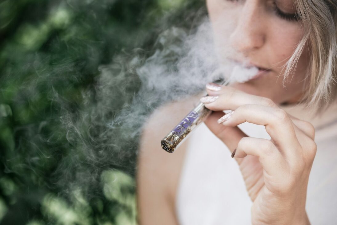 Woman smoking cannabis before she starts meditating 